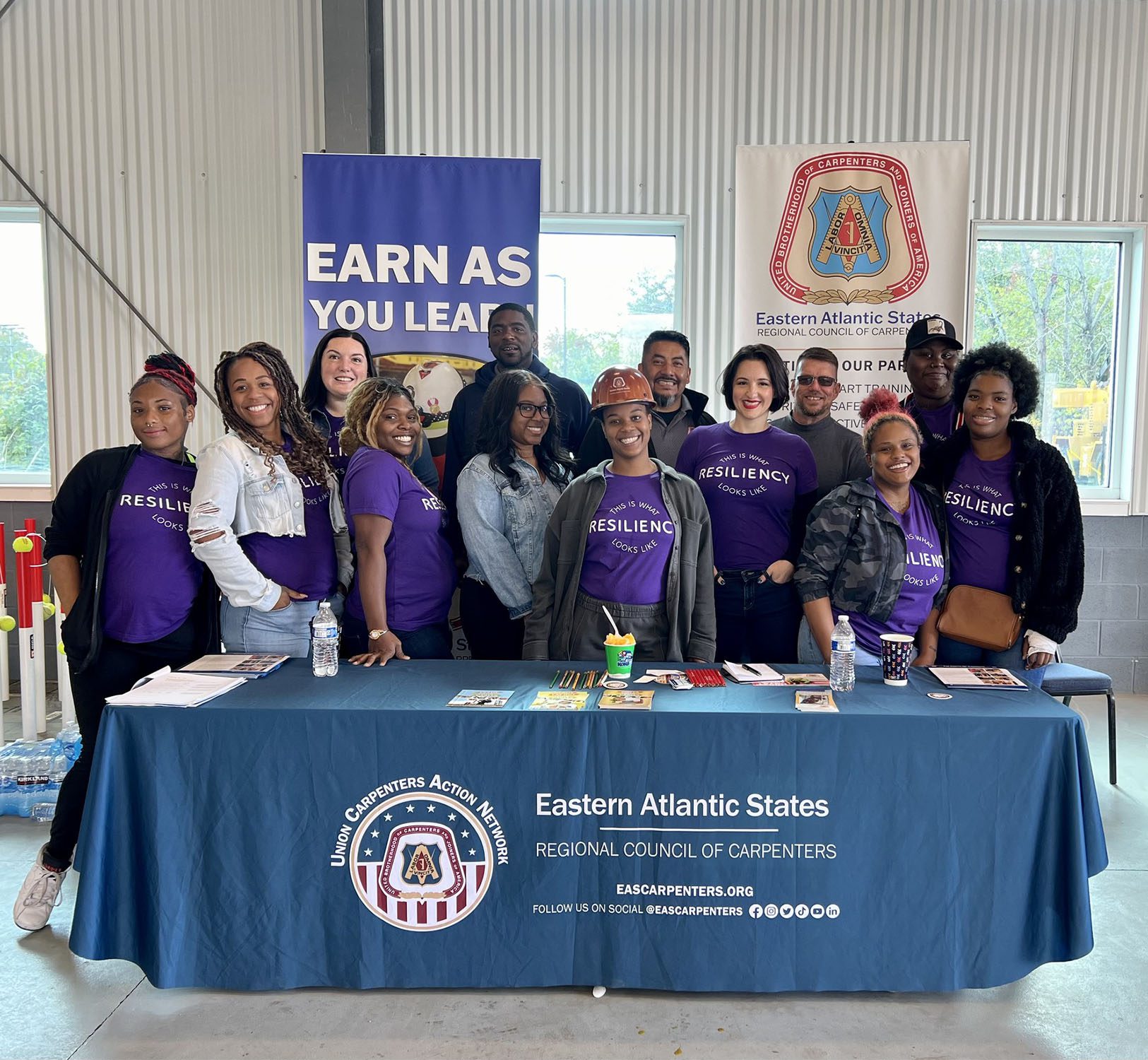 Photo of HER Resiliency triple crown members at a construction fair